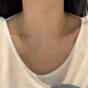 Close-up of minimalist S925 silver beaded chain necklace with reflective gold finish