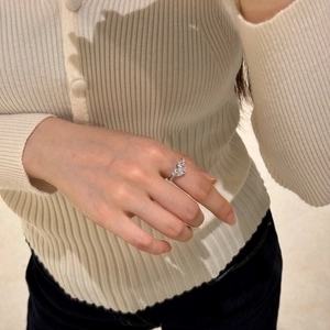 Close-up of S925 sterling silver heart-shaped diamond ring worn on a woman's finger