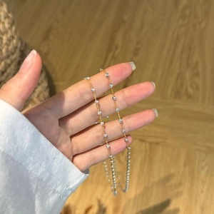 Macro detail of minimalist S925 sterling silver beaded necklace with moon and star accents