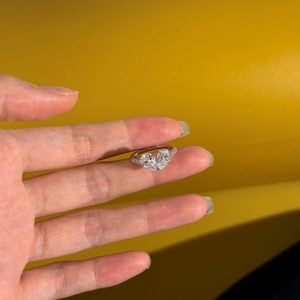 Macro view of S925 sterling silver ring featuring double heart-shaped stones and tiny diamonds