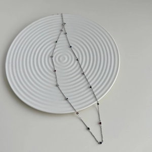 Macro view of S925 silver necklace featuring colorful zircon beads on a fine chain