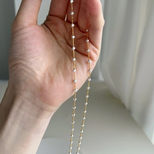 Detail of S925 silver beaded necklace featuring faceted silver beads and gold chain