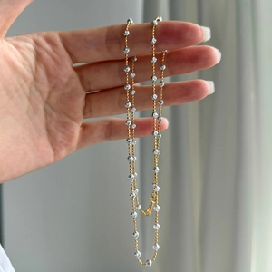 Close-up of S925 silver beaded necklace with faceted beads and lobster clasp detail