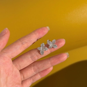 Detailed view of silver butterfly stud earrings with sparkling pavé cubic zirconia
