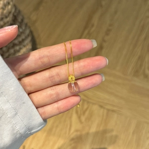 Minimalist S925 silver necklace with golden flower petals and a white crystal pendant