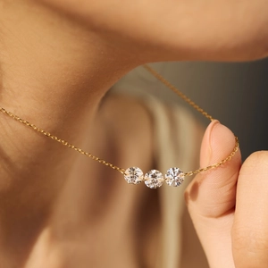 Elegant gold S925 sterling silver necklace featuring three sparkling round zirconia stones