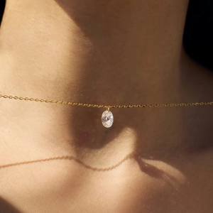 Elegant gold S925 sterling silver necklace with oval zircon pendant on a female model