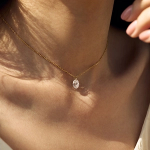 Elegant S925 sterling silver necklace featuring an oval mermaid tear pendant on a gold chain