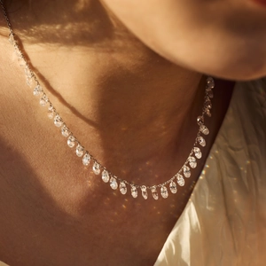 Elegant S925 sterling silver necklace with oval-cut dangling crystals on model