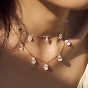 Layered S925 silver and gold necklaces with pear-cut zircon waterdrop pendants on neck