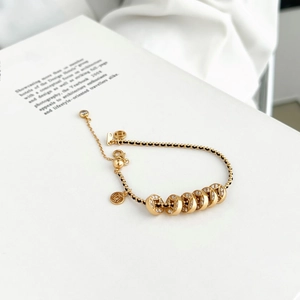 Bracciale in argento S925 con cordino nero intrecciato e monete d'oro 18 carati