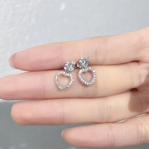 Macro shot of S925 sterling silver heart earrings with hollow crystal pave detailing