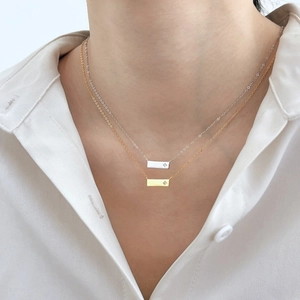 Collana minimalista in argento S925 con barra incisa a stella indossata in oro e argento
