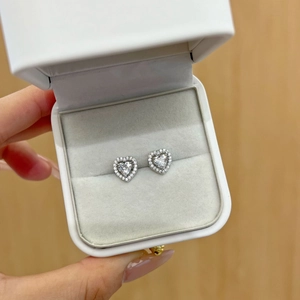 Macro detail of S925 sterling silver heart earrings with sparkling pave zircon stones