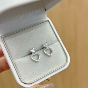 Detail view of heart-shaped S925 sterling silver studs with zircon in a jewelry box