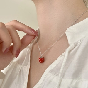 S925 Sterling silver strawberry pendant necklace on a woman wearing white shirt
