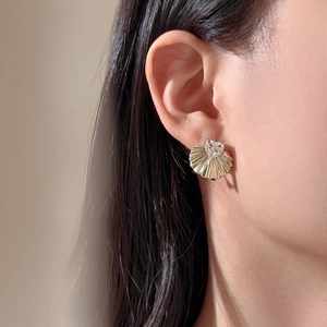 Elegant S925 sterling silver fan-shaped stud earrings with heart zircon on model