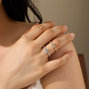 Elegant S925 sterling silver halo rings in silver and gold colors worn by a model