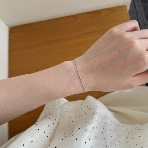 Detailed view of minimalist S925 sterling silver snake chain on wrist for daily wear