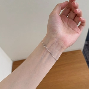 Detail of minimalist S925 sterling silver snake chain bracelet with spring ring clasp