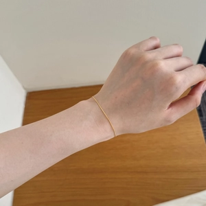 Minimalist gold snake chain bracelet on wrist showing a lightweight everyday wear look