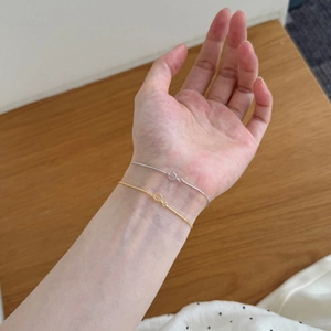 Minimalist S925 sterling silver snake chain bracelets in gold and silver on a wrist