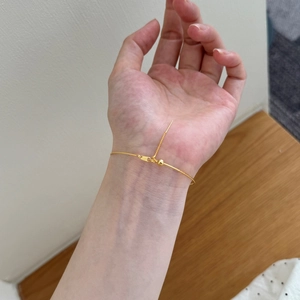 Detailed view of S925 sterling silver stamp on the adjustable golden chain bracelet
