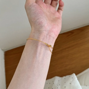 Minimalist adjustable gold chain bracelet for women on wrist with slider bead closure
