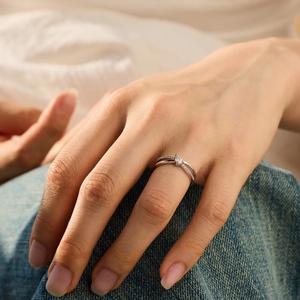 Elegant S925 sterling silver criss-cross ring with pavé diamonds on woman hand