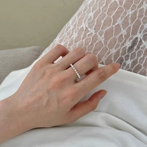 Elegant S925 sterling silver ring featuring a row of small pearls on a slim silver band