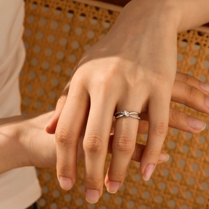 Close-up of S925 silver criss-cross ring featuring a pear-cut stone on a hand