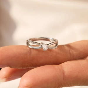 S925 sterling silver ring featuring a pear-cut gemstone and crisscross pavé band
