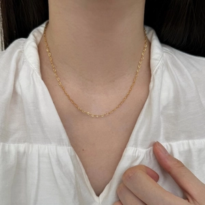 Close-up of elegant gold S925 sterling silver necklace featuring hollow heart-shaped links