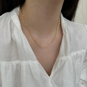 Close-up of a S925 sterling silver golden chain with interlocking heart-shaped links