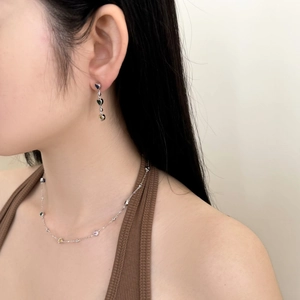 Close-up of S925 silver colorful heart tassel earrings and necklace set on a model