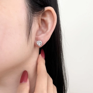 Elegant S925 sterling silver heart stud earrings with sparkling cubic zirconia on a model