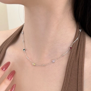 Detail of silver chain necklace featuring vibrant multi-colored heart-shaped zircon stones