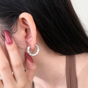 Elegant S925 sterling silver hoop earrings with frosted texture shown on a female model