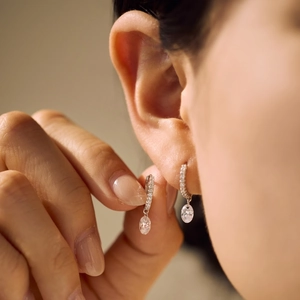 S925 sterling silver drop earrings with oval cubic zirconia on a female model