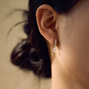 Detailed close-up of S925 silver oval pendant earrings featuring sparkling pavé crystals