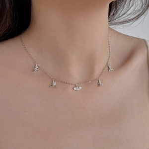 Détail du collier en argent sterling S925 avec pendentifs colibri et abeille sur modèle