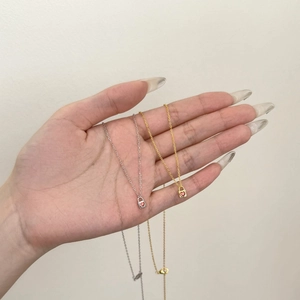 S925 sterling silver heart padlock necklaces in gold and silver held in hand