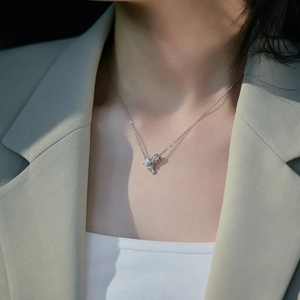 Elegant S925 sterling silver bow pendant necklace with zircons worn by a model