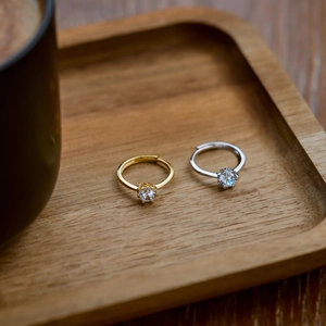 Macro view of gold and silver adjustable six-prong round cubic zirconia open rings