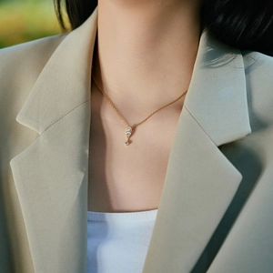 Close-up of S925 silver necklace with marquise cut crystal pendant on a woman neck