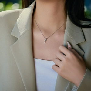 Detail of S925 sterling silver necklace with marquise cut crystal pendant on model