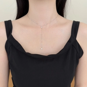Detail view of a refined S925 sterling silver Y-shaped necklace with zircon pendants