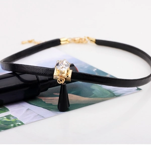 Modern black leather choker with gold claw-set crystal and water drop pendant
