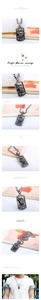 Detail view of vintage silver rectangular pendant with skeleton hand and skull accents