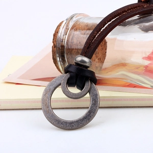 Vintage leather cord necklace featuring dual distressed metal rings and adjustable bead